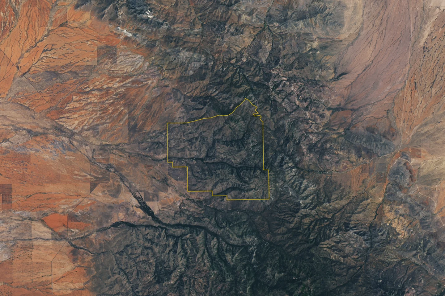 Satellite view of the terrain around Chiricahua, Arizona, with a territorial boundary marked in yellow.